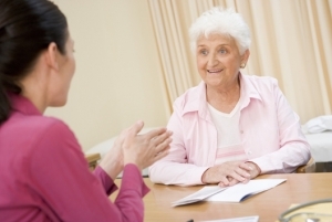 Woman in doctor's office smiling and discussing urological condition